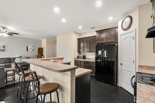 144 Caledonia Dr, Easley, SC 29642 - kitchen featuring black fridge with ice dispenser, electric range oven, dark brown cabinetry, a breakfast bar area, and open floor plan