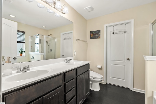 144 Caledonia Dr, Easley, SC 29642 - bathroom featuring a stall shower, double vanity, and wood finished floors