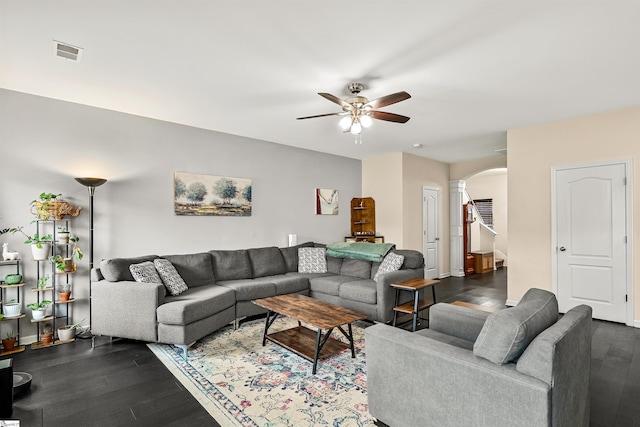 144 Caledonia Dr, Easley, SC 29642 - living room with arched walkways, ceiling fan, dark wood-style floors, and decorative columns