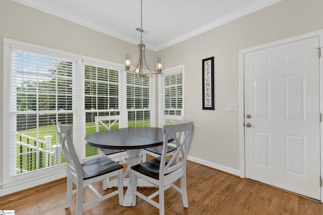 3 Promontory Ct, Greenville, SC 29615 - dining area featuring plenty of natural light, a chandelier, ornamental molding, and light wood-style flooring