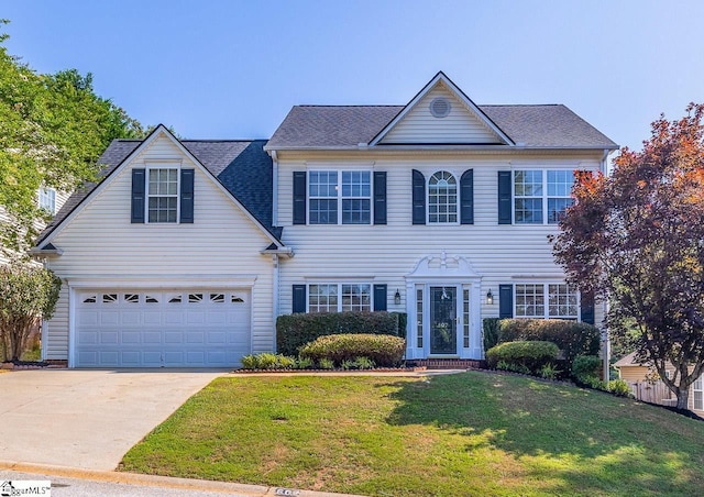 607 Greening Dr, Simpsonville, SC 29681 - colonial house with driveway, a front yard, and an attached garage