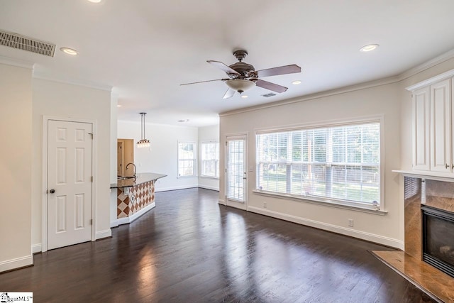 607 Greening Dr, Simpsonville, SC 29681 - unfurnished living room with dark wood-type flooring, a premium fireplace, crown molding, ceiling fan, and recessed lighting