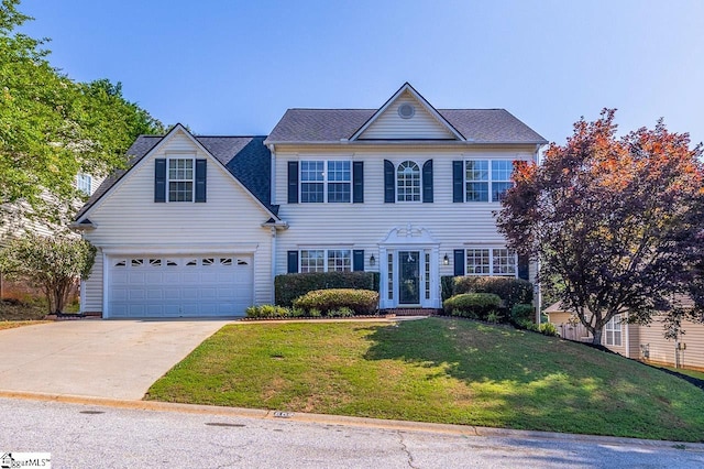 607 Greening Dr, Simpsonville, SC 29681 - colonial-style house with concrete driveway, a front lawn, and an attached garage