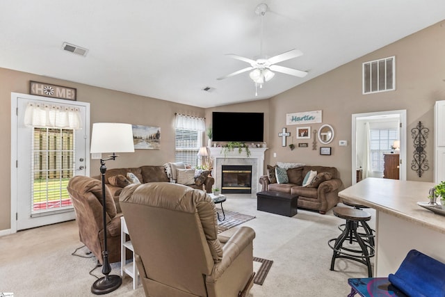 243 Rivers Edge Dr, Easley, SC 29642 - living area featuring light colored carpet, ceiling fan, lofted ceiling, and a premium fireplace