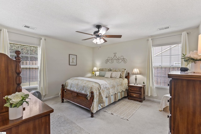 243 Rivers Edge Dr, Easley, SC 29642 - bedroom featuring multiple windows, light colored carpet, a textured ceiling, and a ceiling fan