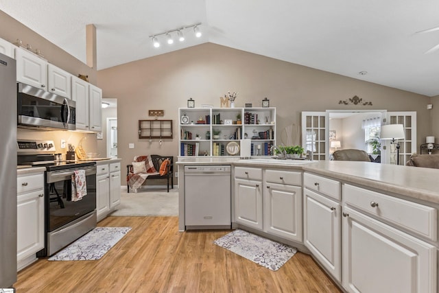 243 Rivers Edge Dr, Easley, SC 29642 - kitchen with appliances with stainless steel finishes, lofted ceiling, open floor plan, white cabinetry, and light wood-type flooring
