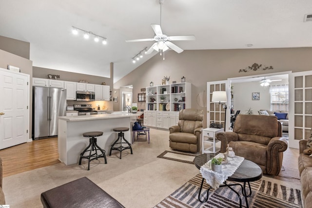 243 Rivers Edge Dr, Easley, SC 29642 - living room with a ceiling fan, french doors, track lighting, light carpet, and high vaulted ceiling