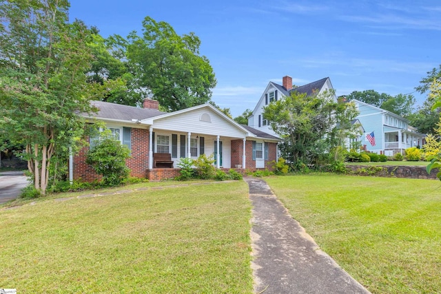 15 Jones Ave, Greenville, SC 29601 - view of front facade featuring brick siding, a porch, a chimney, and a front yard