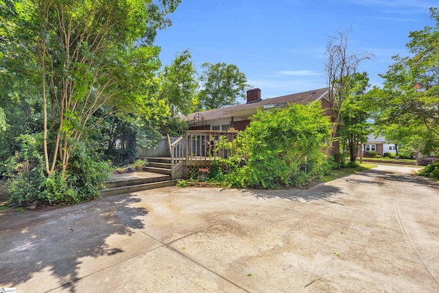 15 Jones Ave, Greenville, SC 29601 - rear view of property with a deck, a chimney, and driveway