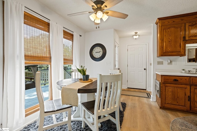 105 Fox Chase Ct, Simpsonville, SC 29680 - dining area featuring light wood-style floors, a ceiling fan, and a textured ceiling
