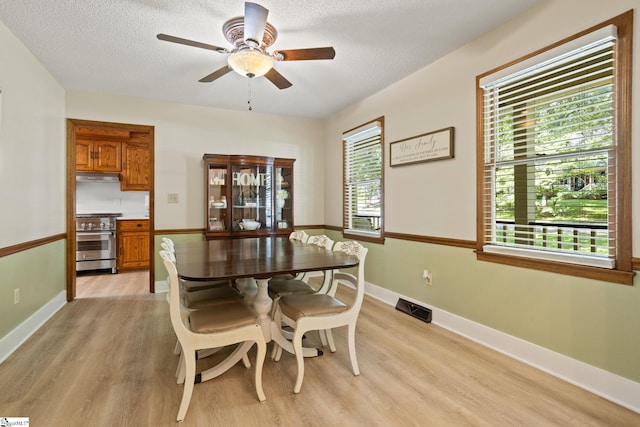 105 Fox Chase Ct, Simpsonville, SC 29680 - dining space featuring light wood-type flooring, a ceiling fan, and a textured ceiling