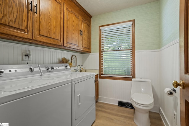 105 Fox Chase Ct, Simpsonville, SC 29680 - laundry room with washer and dryer, light wood-style floors, wainscoting, and wallpapered walls