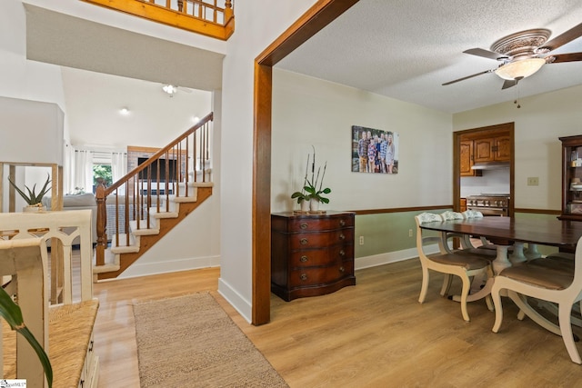 105 Fox Chase Ct, Simpsonville, SC 29680 - dining room featuring ceiling fan, light wood finished floors, stairway, and a textured ceiling