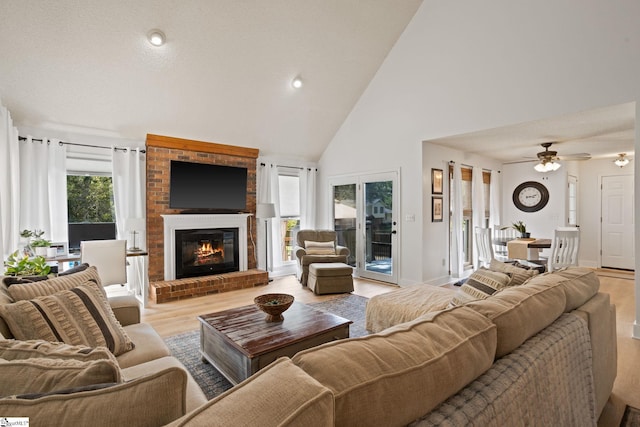 105 Fox Chase Ct, Simpsonville, SC 29680 - living area featuring light wood-type flooring, a brick fireplace, high vaulted ceiling, and ceiling fan