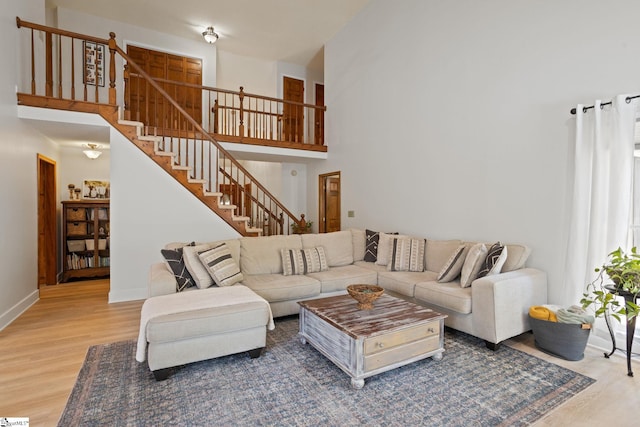 105 Fox Chase Ct, Simpsonville, SC 29680 - living area with wood finished floors, a towering ceiling, and stairs