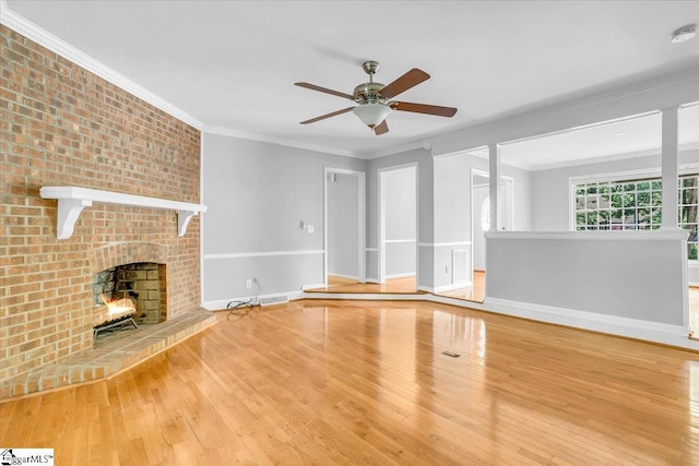 402 Rosebud Ct, Greer, SC 29650 - unfurnished living room featuring crown molding, wood finished floors, a ceiling fan, and a brick fireplace