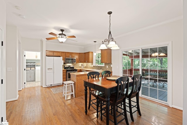 629 Germander Ct, Greer, SC 29651 - dining room with light wood-style flooring, ornamental molding, and a ceiling fan