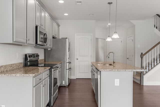 138 Rushing Creek Ln, Piedmont, SC 29673 - kitchen featuring appliances with stainless steel finishes, dark wood-style floors, a center island with sink, recessed lighting, and light stone countertops