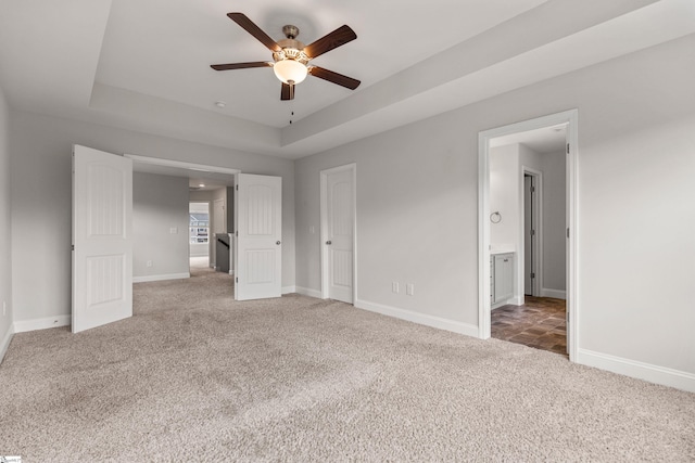 138 Rushing Creek Ln, Piedmont, SC 29673 - unfurnished bedroom featuring carpet flooring, a tray ceiling, ensuite bath, and ceiling fan