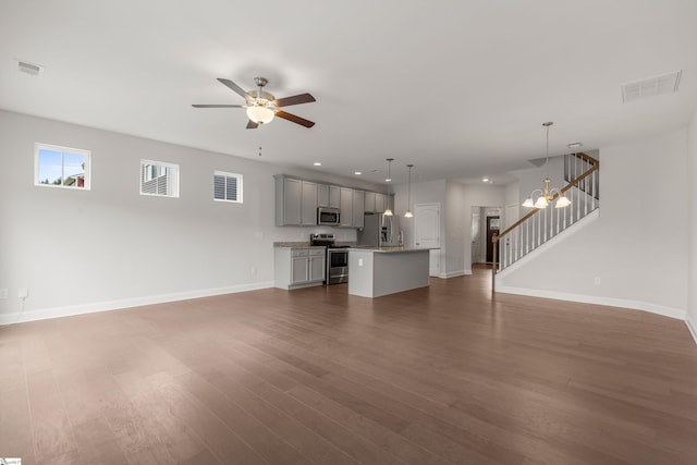 138 Rushing Creek Ln, Piedmont, SC 29673 - unfurnished living room with stairs, dark wood-style flooring, ceiling fan, and recessed lighting