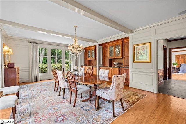 4 Huntington Ct, Greenville, SC 29615 - dining area with a decorative wall, a chandelier, ornamental molding, light wood-style floors, and beam ceiling