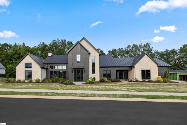 304 Waterford Fall Way, Simpsonville, SC 29681 - modern inspired farmhouse featuring a standing seam roof, a metal roof, a front lawn, board and batten siding, and french doors