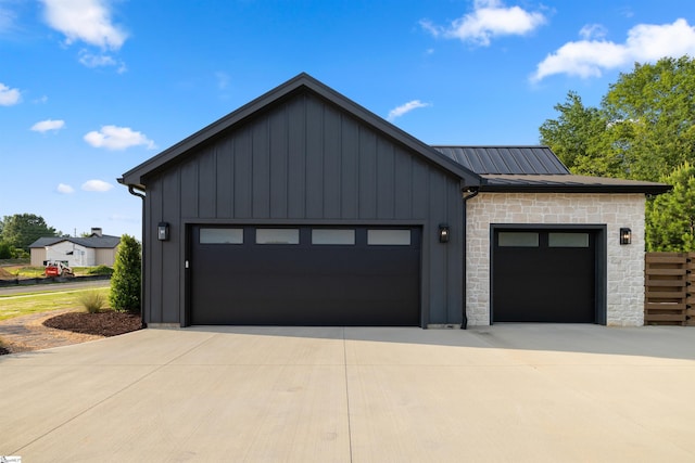 304 Waterford Fall Way, Simpsonville, SC 29681 - view of front facade featuring board and batten siding, stone siding, a metal roof, a garage, and concrete driveway