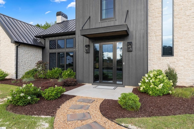 304 Waterford Fall Way, Simpsonville, SC 29681 - doorway to property featuring a standing seam roof, french doors, stone siding, and a chimney