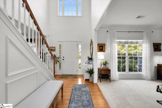 9 Springhead Way, Greer, SC 29650 - foyer featuring plenty of natural light, stairway, wood finished floors, and a towering ceiling