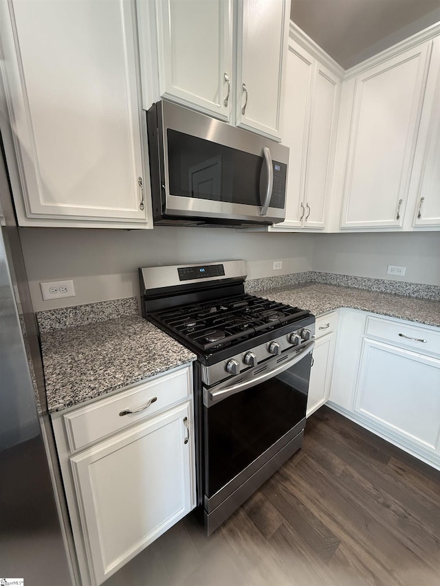 158 Clingstone Trl, Duncan, SC 29334 - kitchen featuring stainless steel appliances, white cabinets, light stone counters, and dark wood-style floors