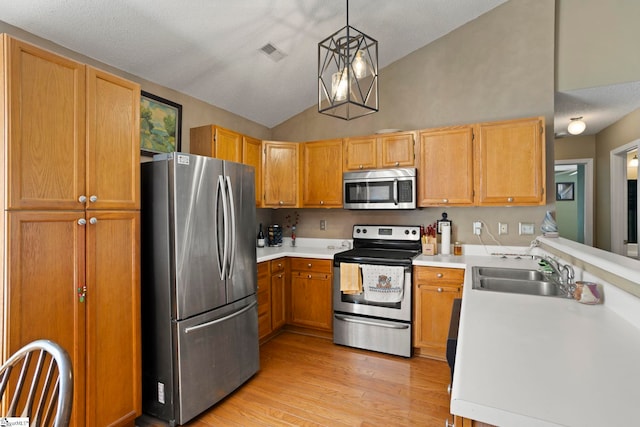17 Lantern Ln, Greer, SC 29651 - kitchen with appliances with stainless steel finishes, light wood-type flooring, light countertops, decorative light fixtures, and high vaulted ceiling