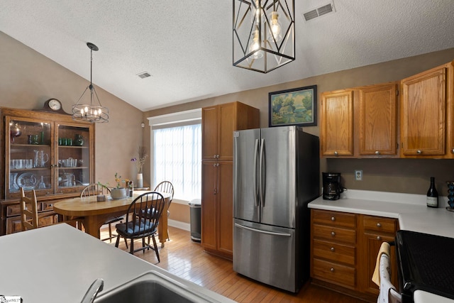 17 Lantern Ln, Greer, SC 29651 - kitchen featuring freestanding refrigerator, a chandelier, range, a textured ceiling, and lofted ceiling