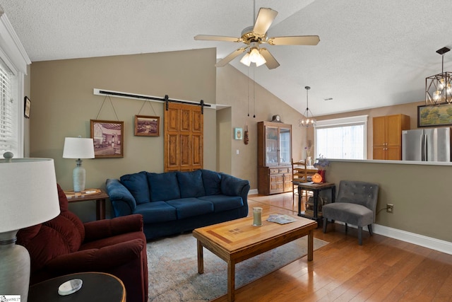 17 Lantern Ln, Greer, SC 29651 - living area with light wood-type flooring, vaulted ceiling, a textured ceiling, ceiling fan, and a barn door