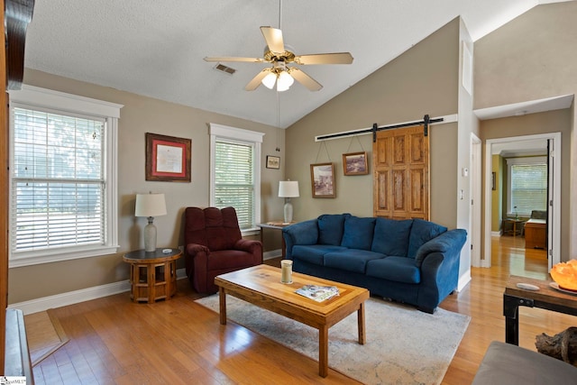 17 Lantern Ln, Greer, SC 29651 - living area featuring a barn door, ceiling fan, light wood-type flooring, and high vaulted ceiling
