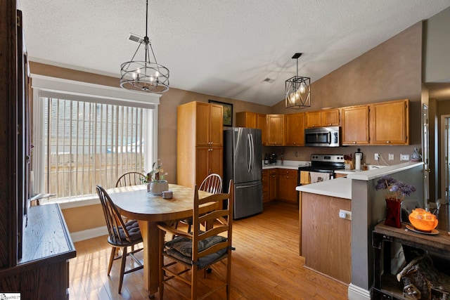 17 Lantern Ln, Greer, SC 29651 - kitchen featuring appliances with stainless steel finishes, a chandelier, light countertops, pendant lighting, and a textured ceiling