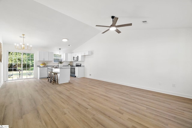 204 Dexter Bend Ct, Fountain Inn, SC 29644 - living room with a chandelier, light wood-style flooring, a ceiling fan, and lofted ceiling