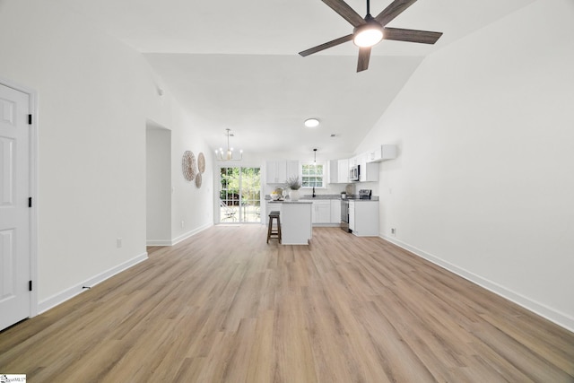 204 Dexter Bend Ct, Fountain Inn, SC 29644 - unfurnished living room with a chandelier, ceiling fan, light wood-style floors, and high vaulted ceiling