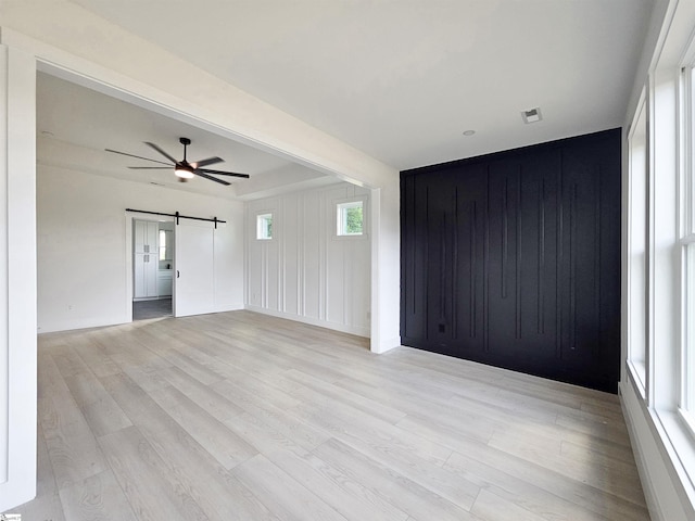 162 Refuge Church Rd, Central, SC 29630 - unfurnished room with a barn door, light wood-style flooring, and a ceiling fan