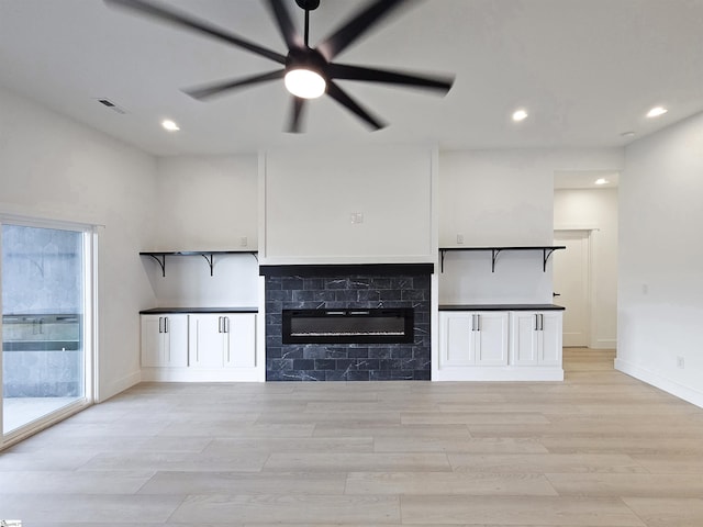 162 Refuge Church Rd, Central, SC 29630 - unfurnished living room featuring ceiling fan, recessed lighting, light wood-type flooring, and a glass covered fireplace