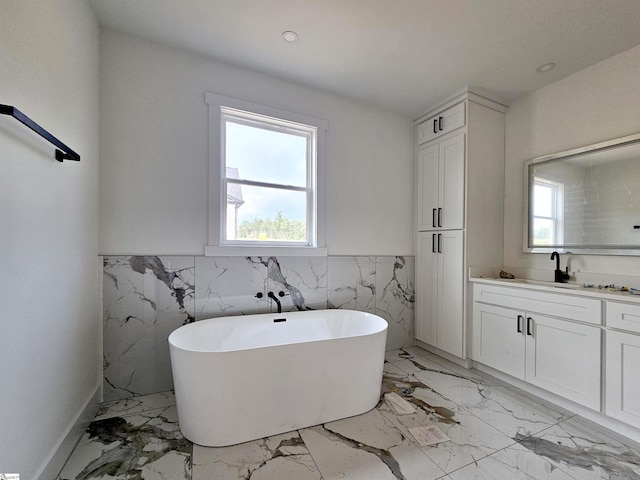 2927 Old Greenville Hwy, Central, SC 29630 - full bathroom featuring vanity, a freestanding bath, healthy amount of natural light, wainscoting, and tile walls