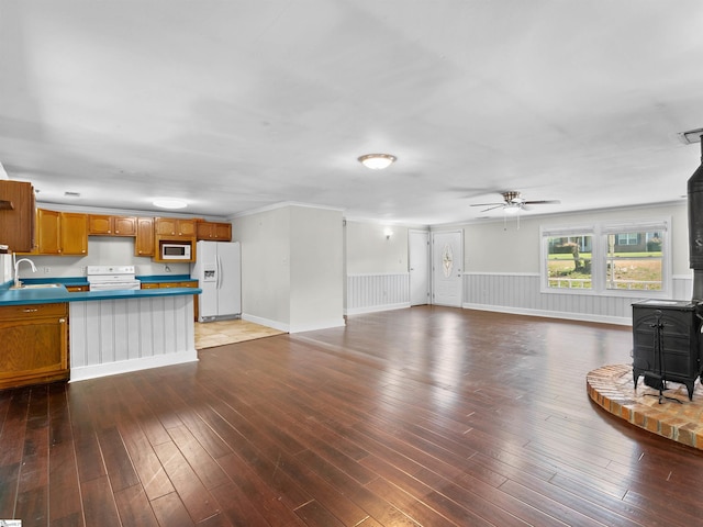 113 Commodore Dr, Duncan, SC 29334 - unfurnished living room featuring a wood stove, a ceiling fan, wainscoting, and wood-type flooring