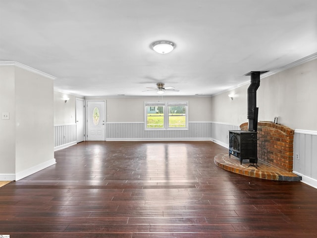 113 Commodore Dr, Duncan, SC 29334 - unfurnished living room featuring ornamental molding, ceiling fan, a wood stove, a wainscoted wall, and wood-type flooring