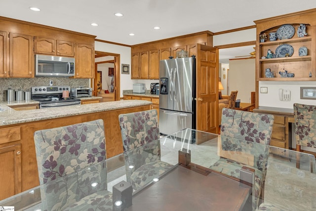 102 Linwood Ct, Simpsonville, SC 29681 - kitchen featuring appliances with stainless steel finishes, ornamental molding, backsplash, light stone countertops, and recessed lighting