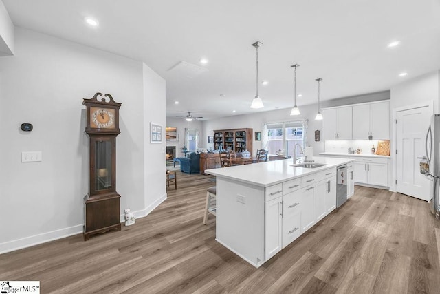 18 Yakama Way, Greenville, SC 29607 - kitchen featuring light wood-type flooring, recessed lighting, white cabinetry, ceiling fan, and a kitchen island with sink