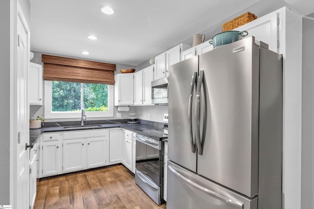 150 Stallings Rd Unit A1, Taylors, SC 19687 - kitchen with stainless steel appliances, dark countertops, white cabinetry, wood finished floors, and recessed lighting
