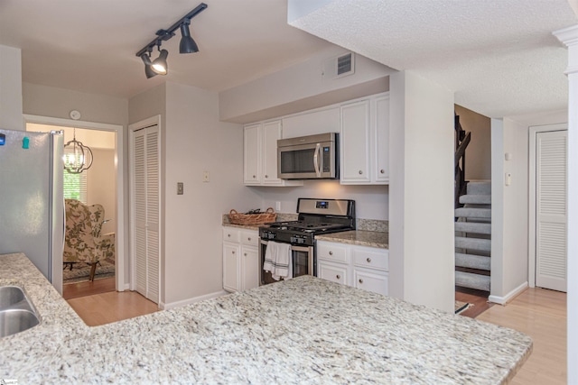 130 Inglewood Way, Greenville, SC 29615 - kitchen featuring appliances with stainless steel finishes, light wood-style flooring, track lighting, and white cabinets