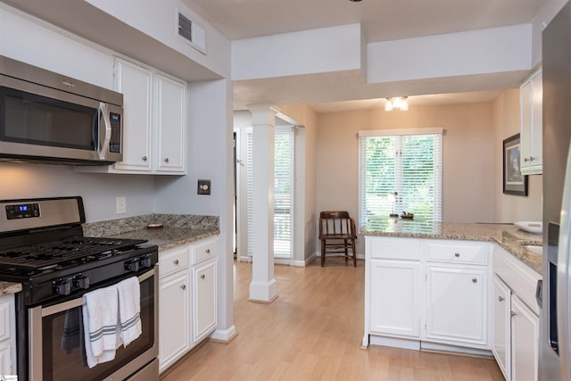 130 Inglewood Way, Greenville, SC 29615 - kitchen featuring appliances with stainless steel finishes, ornate columns, a peninsula, and light wood-style floors