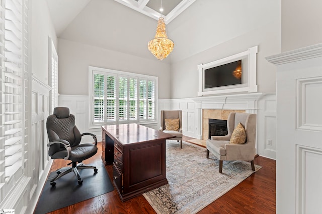 19 Hobcaw Dr, Greer, SC 29650 - home office featuring a decorative wall, dark wood finished floors, a towering ceiling, a tiled fireplace, and a chandelier