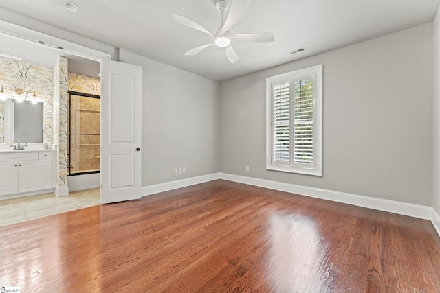 19 Hobcaw Dr, Greer, SC 29650 - unfurnished bedroom featuring light wood-type flooring, connected bathroom, and a ceiling fan