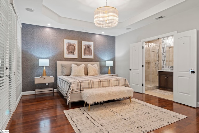 19 Hobcaw Dr, Greer, SC 29650 - bedroom with a chandelier, dark wood-style floors, a raised ceiling, and connected bathroom